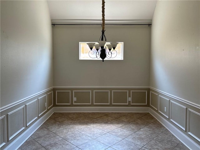 unfurnished dining area with an inviting chandelier and light tile patterned floors