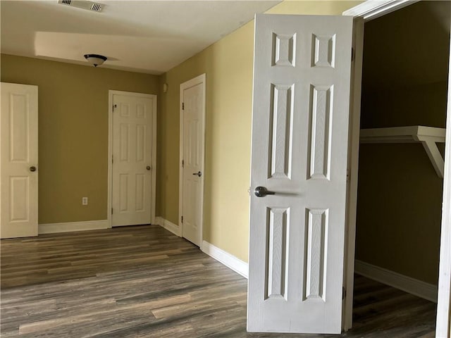 corridor featuring dark wood-type flooring