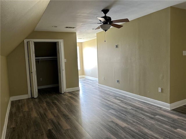 interior space with a textured ceiling, vaulted ceiling, hardwood / wood-style floors, and ceiling fan