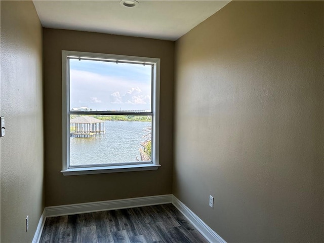 empty room with dark hardwood / wood-style flooring