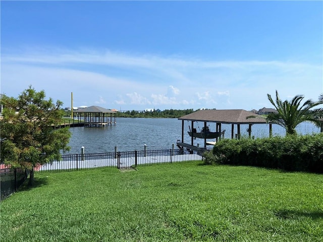 dock area with a water view and a yard