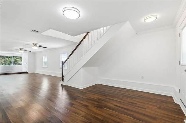 unfurnished living room with ceiling fan, dark hardwood / wood-style floors, and ornamental molding