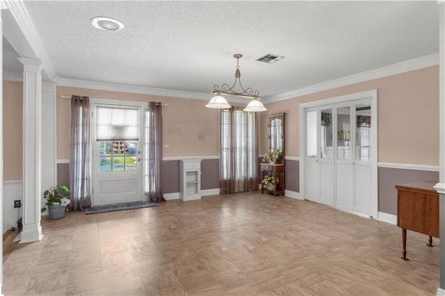 interior space with decorative columns and ornamental molding