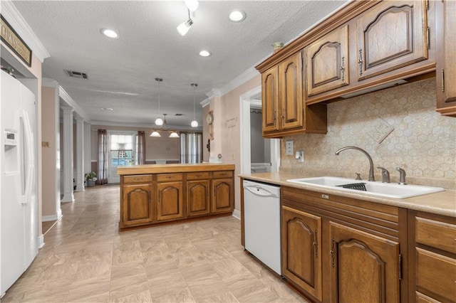 kitchen with tasteful backsplash, white appliances, pendant lighting, sink, and ornamental molding