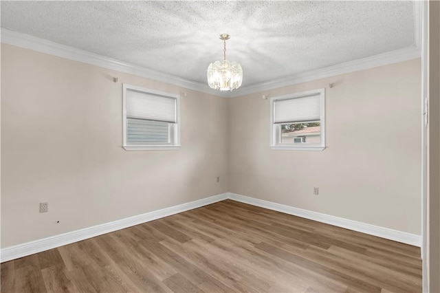 unfurnished room featuring hardwood / wood-style floors, a chandelier, and a textured ceiling