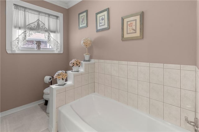 bathroom with a bathing tub, tile patterned flooring, and toilet