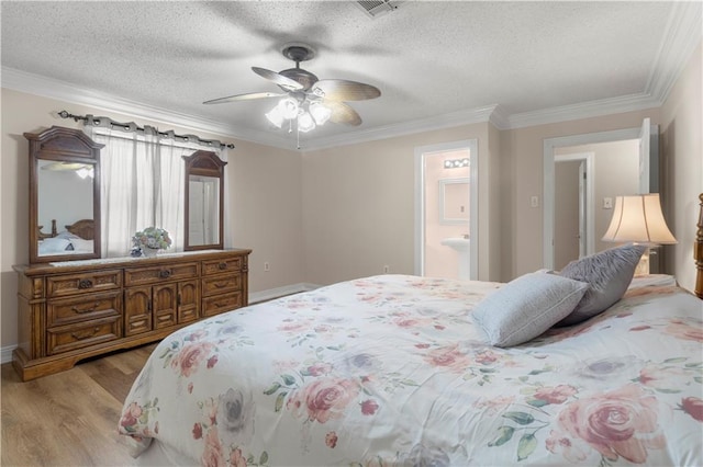 bedroom featuring hardwood / wood-style floors, connected bathroom, a textured ceiling, ceiling fan, and ornamental molding