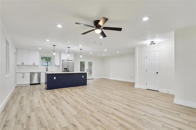 unfurnished living room featuring light hardwood / wood-style floors and ceiling fan