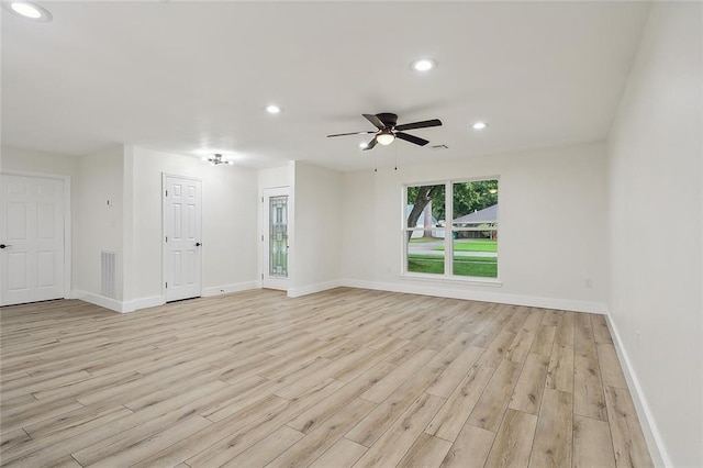 unfurnished room with light wood-type flooring and ceiling fan