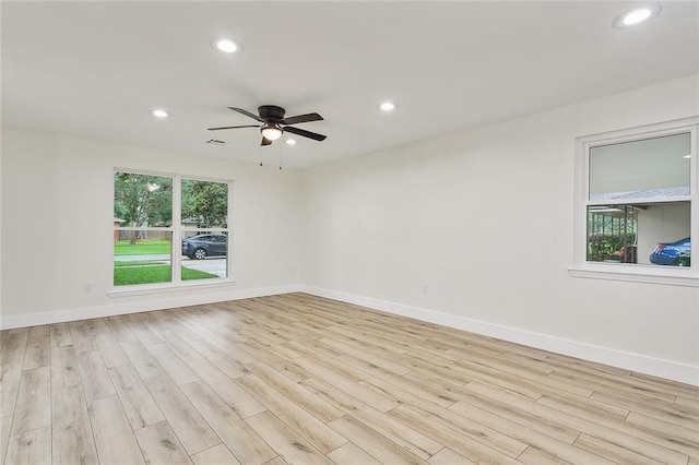 empty room with ceiling fan and light wood-type flooring