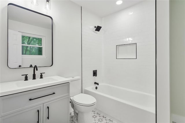 full bathroom with vanity, tile patterned flooring, tiled shower / bath, and toilet