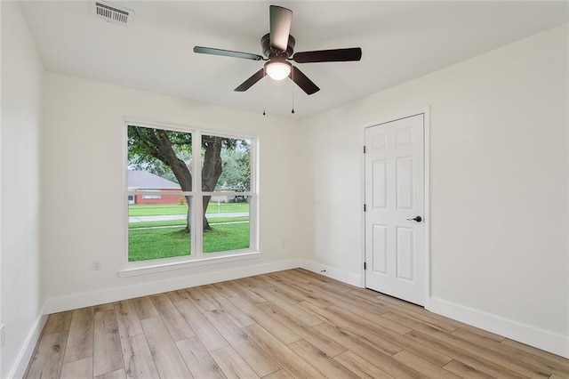 unfurnished room featuring plenty of natural light, light hardwood / wood-style floors, and ceiling fan