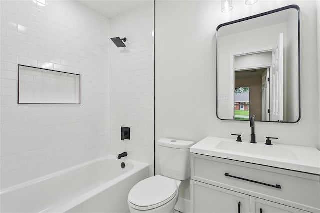 full bathroom with vanity, tiled shower / bath combo, and toilet