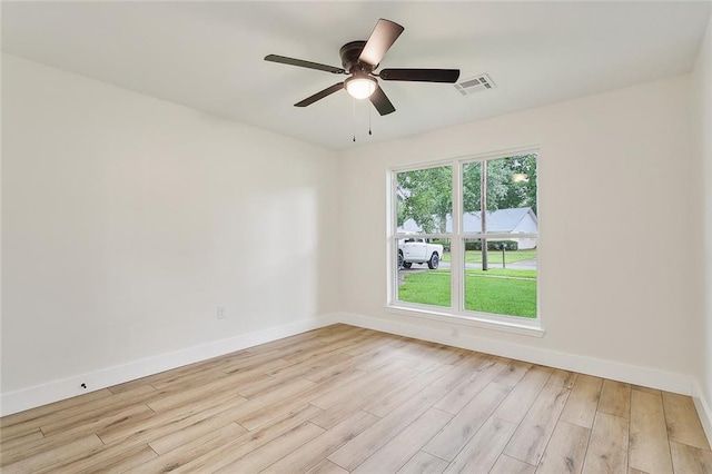 unfurnished room with a wealth of natural light, ceiling fan, and light hardwood / wood-style floors