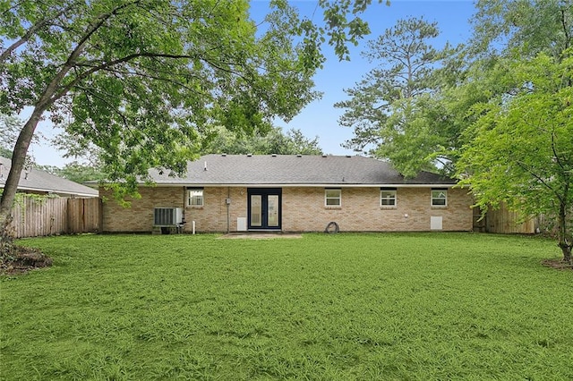 back of house with a yard, central AC, and french doors