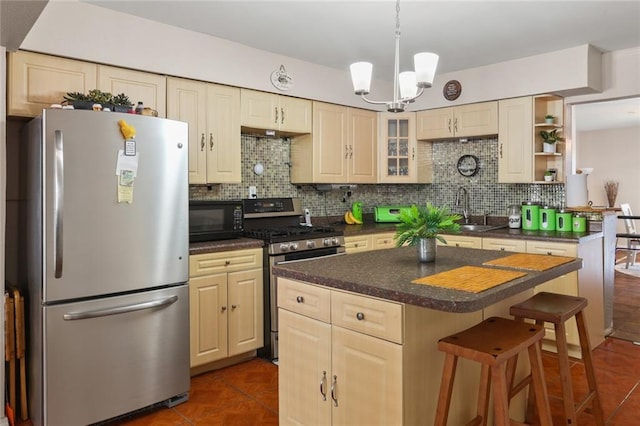 kitchen with sink, a kitchen island, appliances with stainless steel finishes, and backsplash