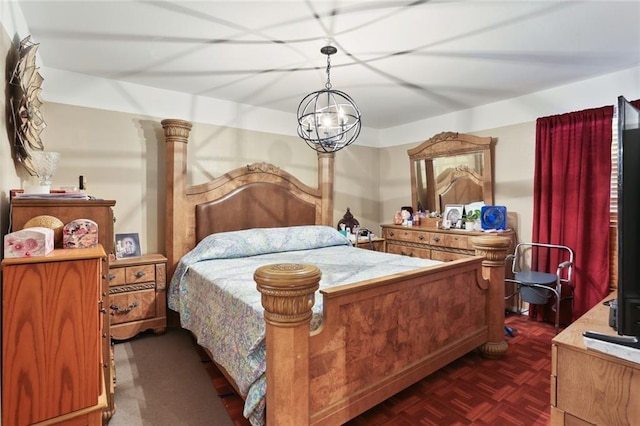 bedroom featuring an inviting chandelier, decorative columns, and dark parquet floors