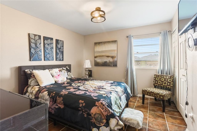 bedroom featuring dark tile patterned floors