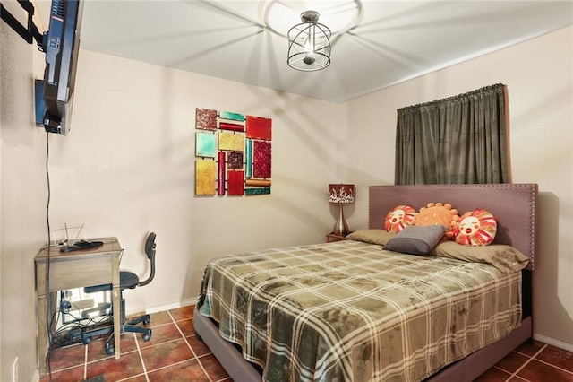 bedroom with dark tile patterned floors