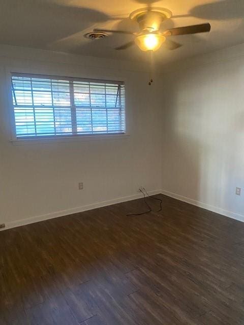 unfurnished room featuring dark hardwood / wood-style floors, a wealth of natural light, and ceiling fan