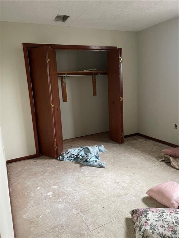 unfurnished bedroom featuring a closet and a textured ceiling