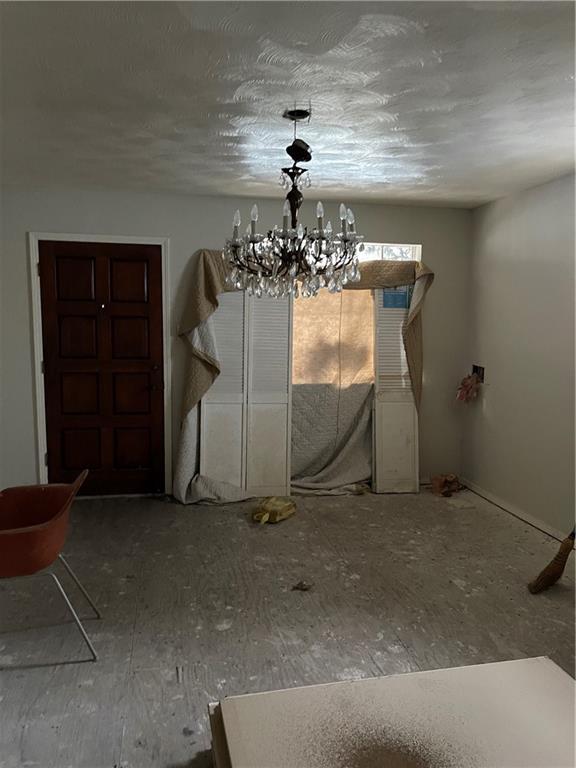 unfurnished dining area with an inviting chandelier