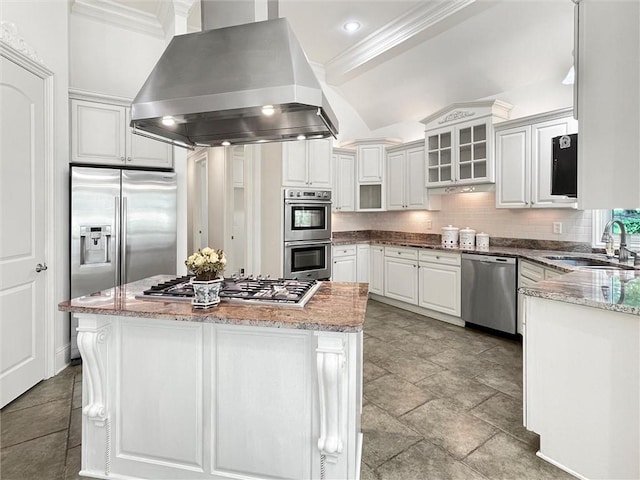 kitchen with white cabinets, sink, light stone countertops, island range hood, and stainless steel appliances