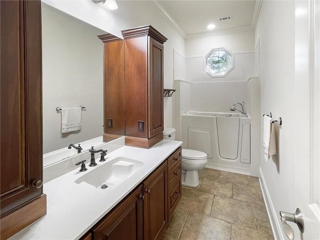 bathroom featuring vanity, toilet, crown molding, and a tub