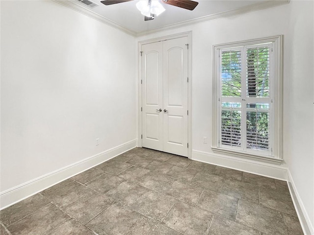 spare room featuring ceiling fan and ornamental molding