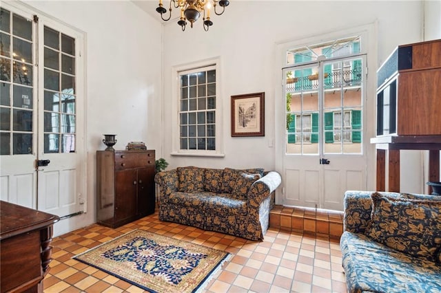 sitting room with light tile patterned floors, an inviting chandelier, and a healthy amount of sunlight