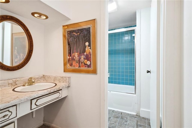 bathroom with sink and tiled shower / bath