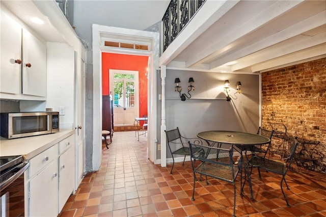 kitchen featuring white cabinets, light tile patterned floors, and appliances with stainless steel finishes