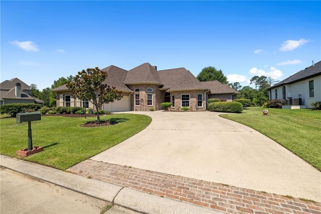 french provincial home with a garage and a front lawn