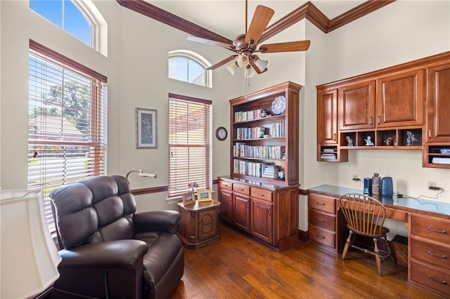 home office with dark hardwood / wood-style flooring, built in desk, plenty of natural light, and ceiling fan