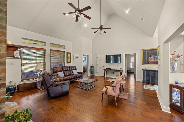 living room with dark hardwood / wood-style floors, ceiling fan, and high vaulted ceiling