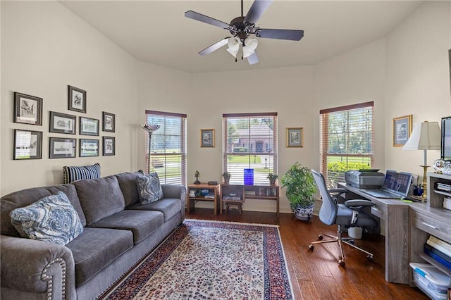 home office with ceiling fan and dark wood-type flooring