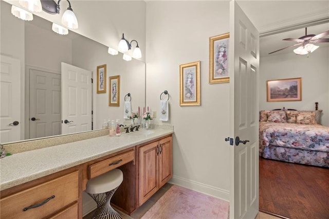 bathroom with hardwood / wood-style floors, vanity, and ceiling fan