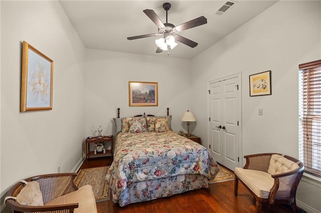 bedroom featuring a closet, ceiling fan, and dark wood-type flooring