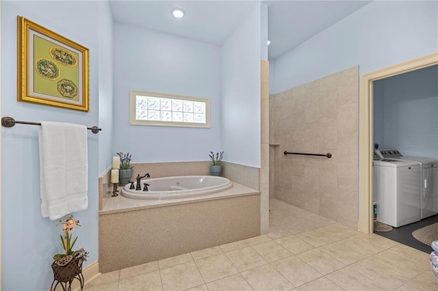 bathroom featuring tile patterned floors, washer and dryer, and shower with separate bathtub