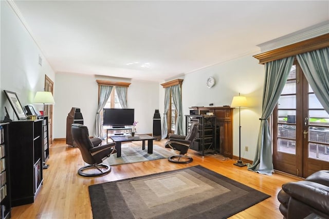 home office with ornamental molding, french doors, and light hardwood / wood-style flooring