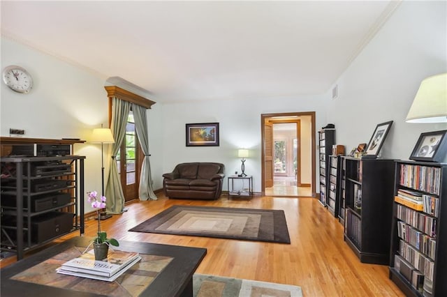 living room featuring light hardwood / wood-style floors and ornamental molding