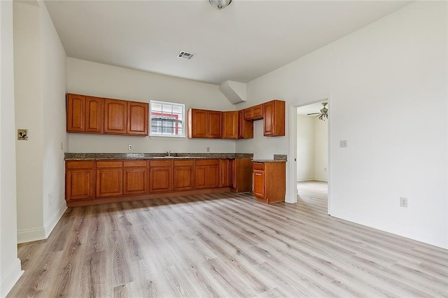 kitchen featuring ceiling fan, light hardwood / wood-style flooring, and sink