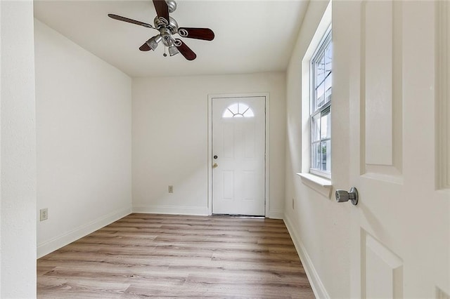 foyer entrance with light wood-type flooring and ceiling fan