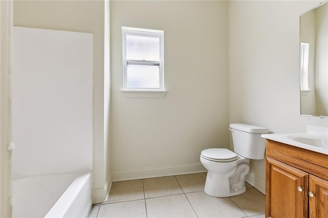 bathroom featuring tile patterned floors, vanity, a bath, and toilet