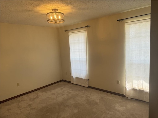 spare room with carpet and a textured ceiling