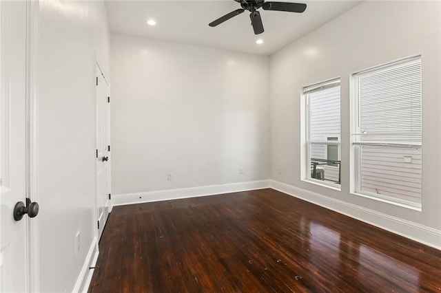 empty room featuring dark hardwood / wood-style flooring and ceiling fan