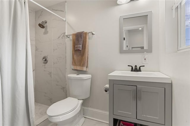 bathroom featuring toilet, vanity, and walk in shower