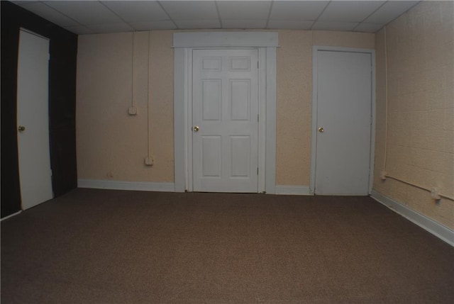 unfurnished bedroom with a drop ceiling and carpet floors