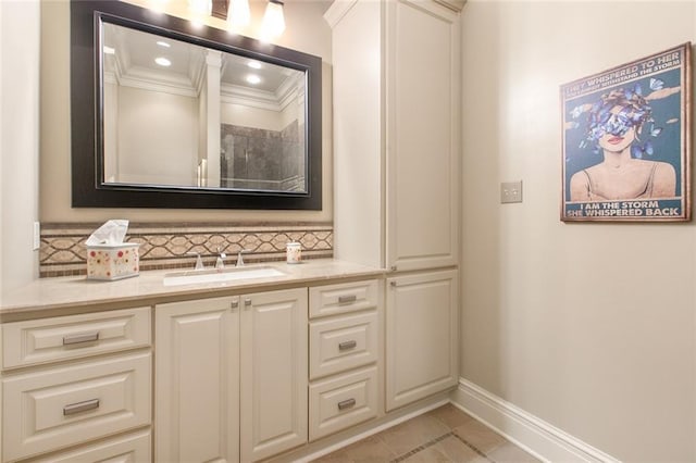 bathroom featuring vanity, baseboards, recessed lighting, decorative backsplash, and crown molding