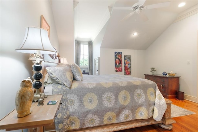 bedroom with lofted ceiling, ornamental molding, a ceiling fan, wood finished floors, and baseboards